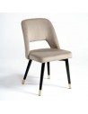 Beige velvet chair with black metal hole and leg and gold cap